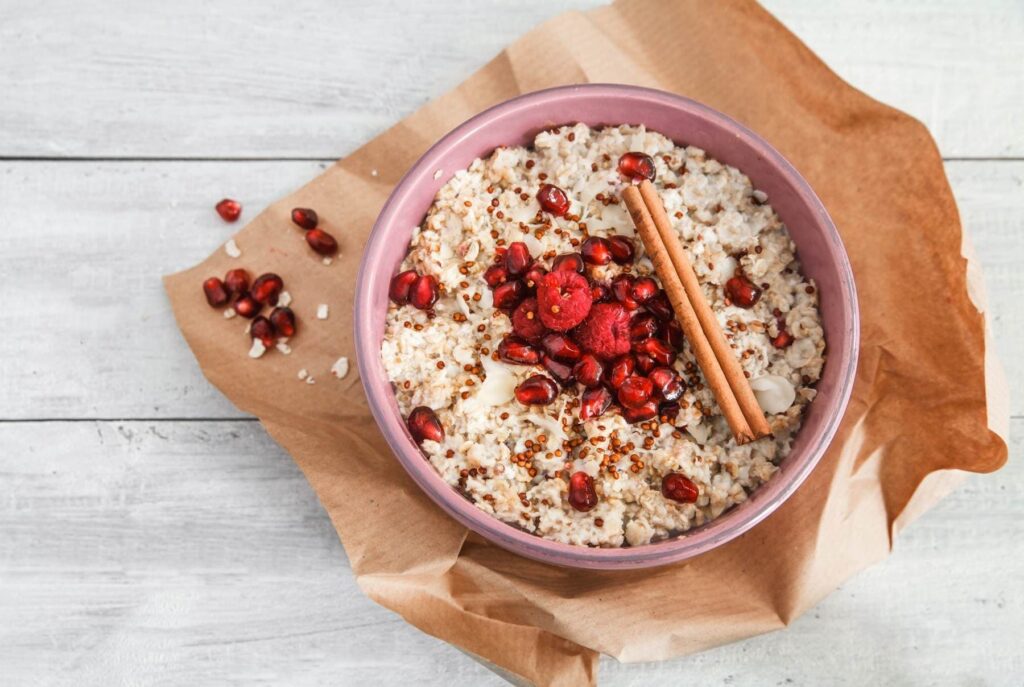 A bowl of quinoa porridge with raspberry.
